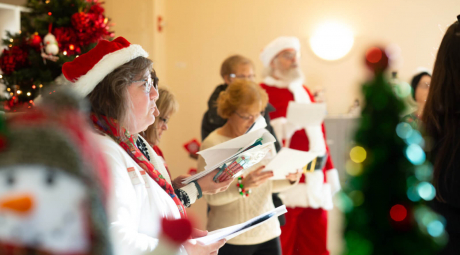 People singing Christmas carols at a long-term care facility.