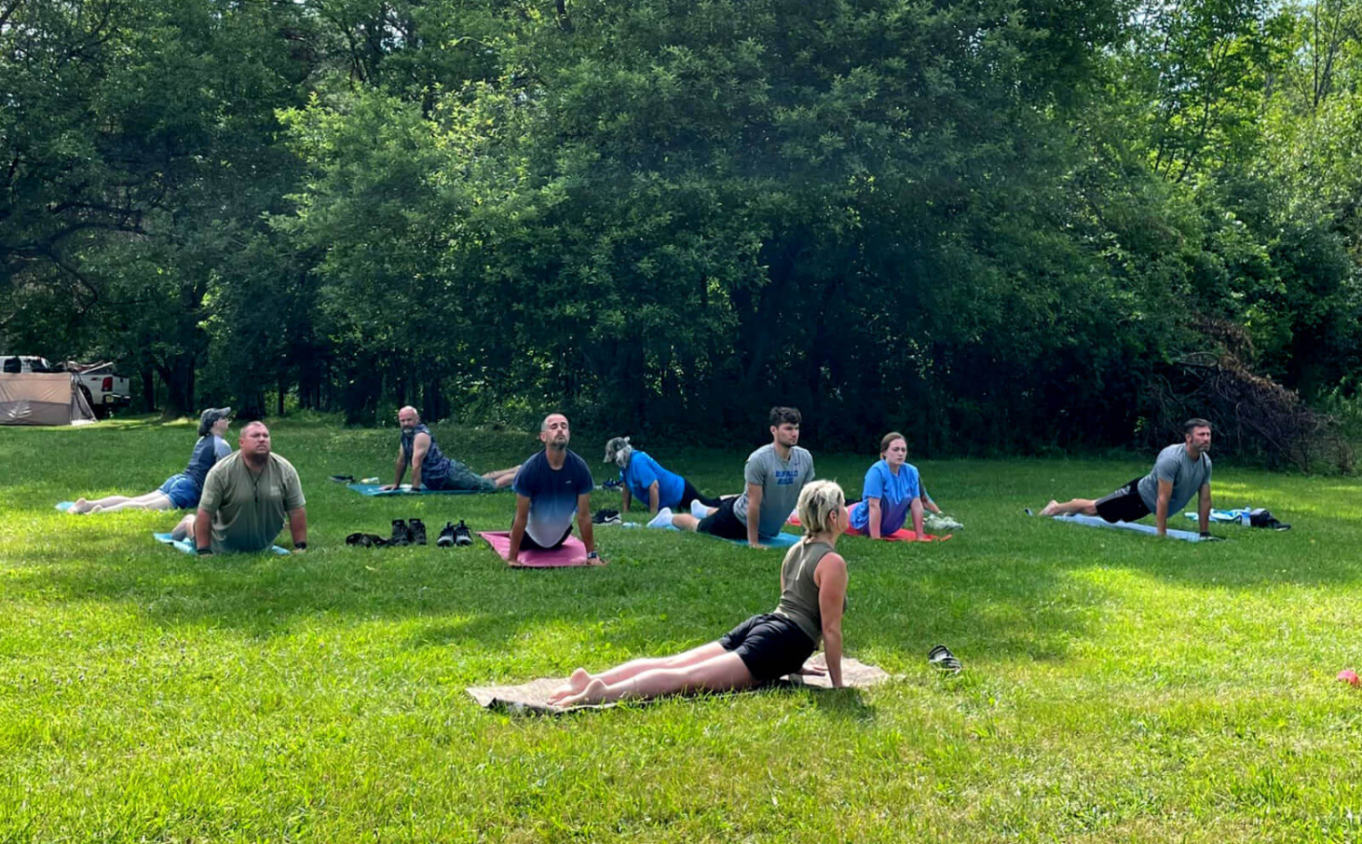 Military veterans enjoying yoga in the park.